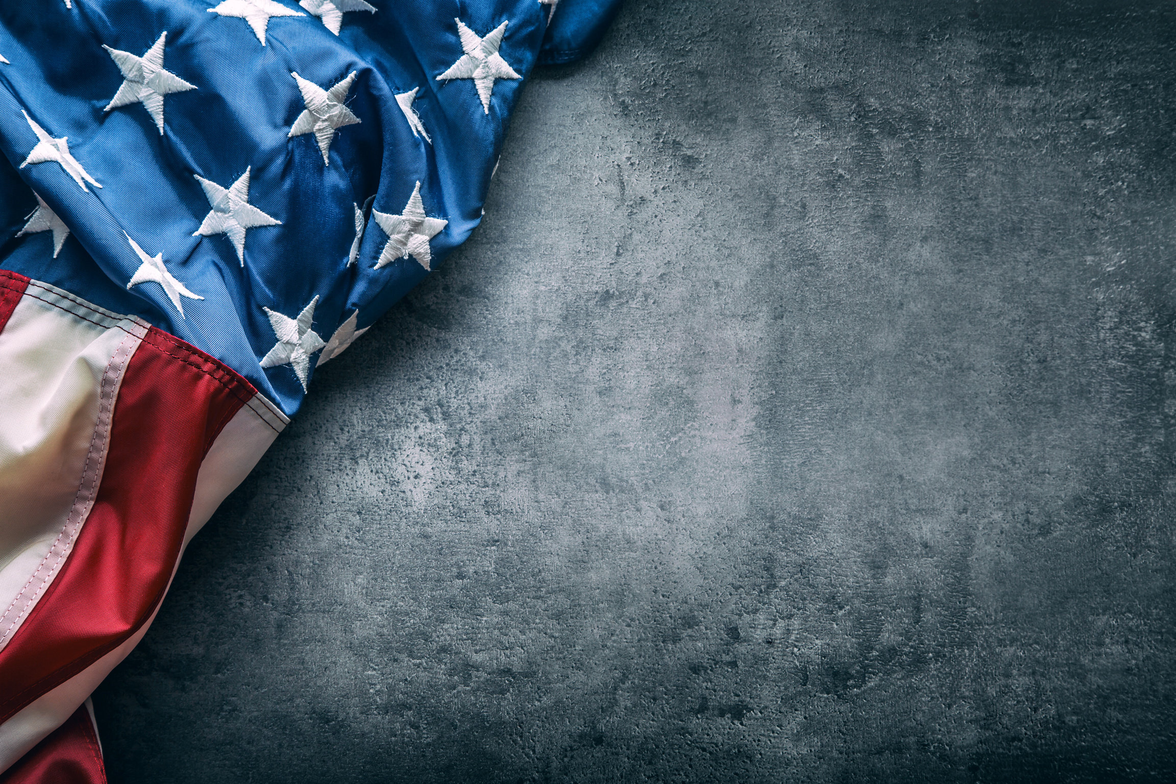 USA flag. American flag freely lying on concrete background.